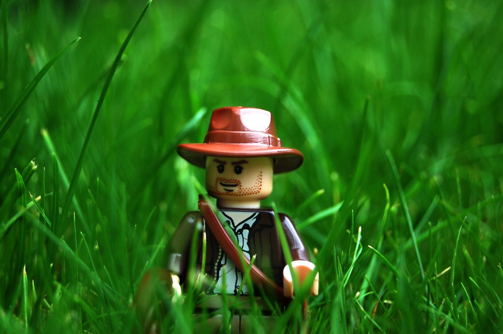 Image of a Lego Indiana Jones in the grass.